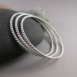 Artisan made thick sterling silver twist bangle by Mikel Grant Jewellery.