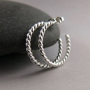 Twisted sterling silver open hoop studs by Mikel Grant Jewellery. Modern, comfortable, artisan made.